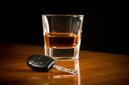 Man Sentenced to 10 Years in Prison for Intoxication Manslaughter 1 Glass of dark liquor on a table next to a car key.