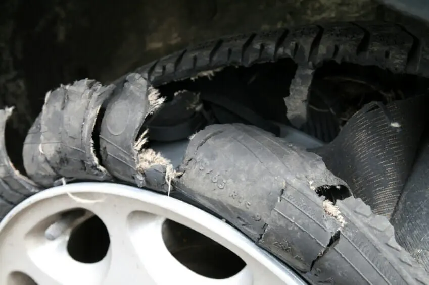 Blog 1 Close up of a destroyed car tire.
