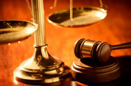 Blog 16 Golden scales and gavel on wood desk