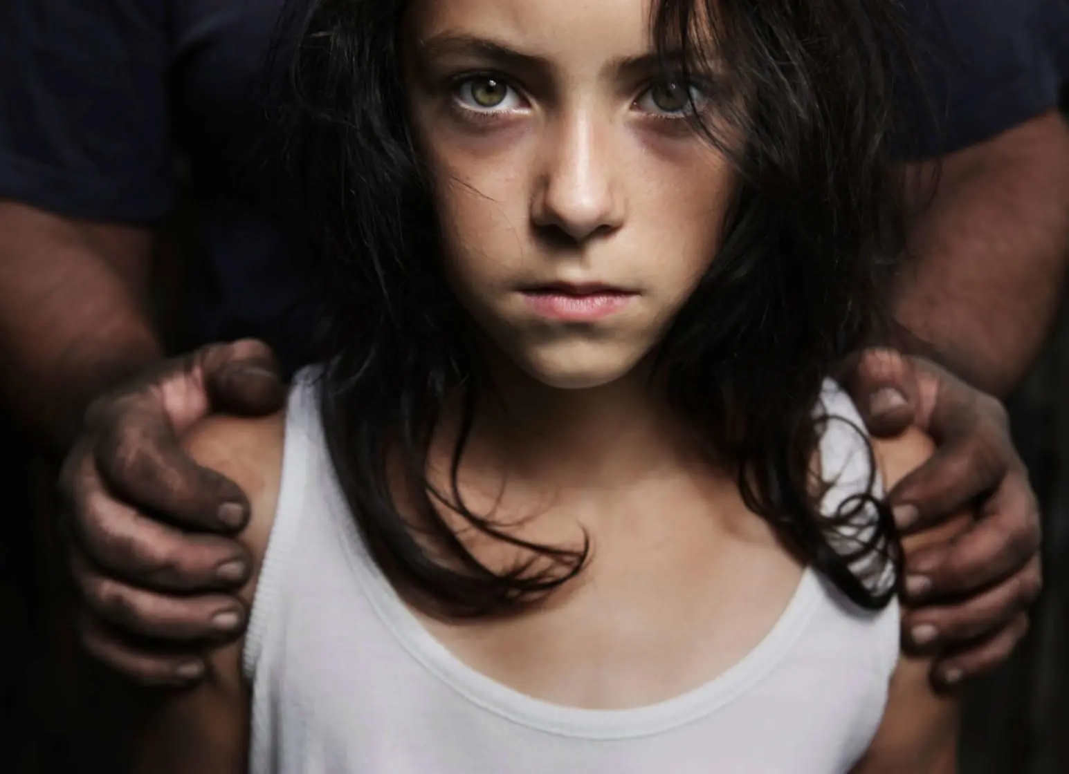 Teen girl being held between two hands
