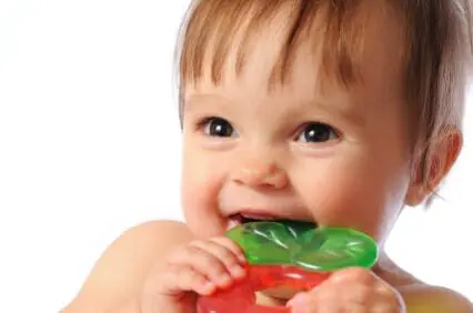 Blog 13 Baby smiling while chewing on a teething ring