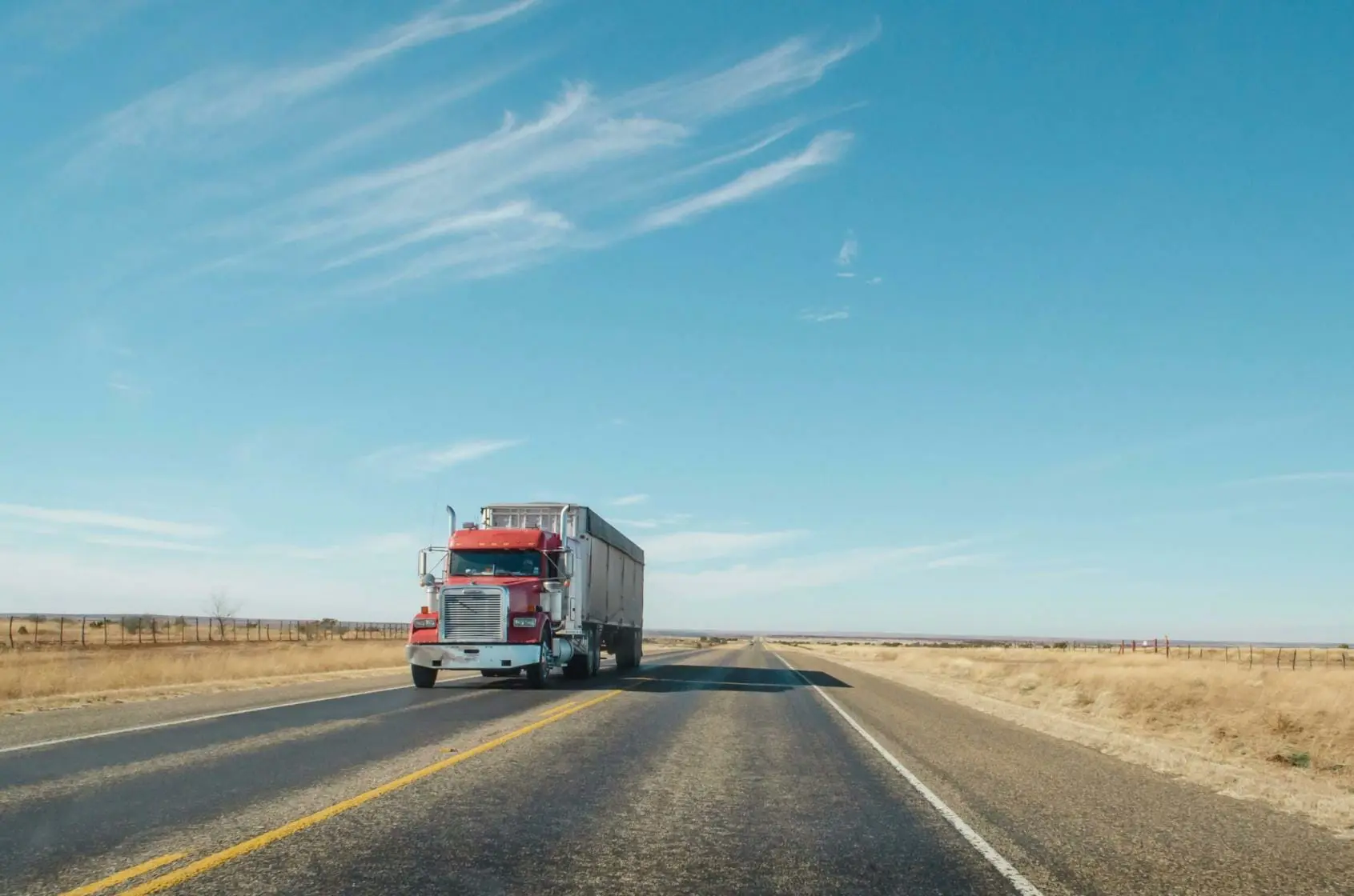 18-wheeler truck traveling down country road