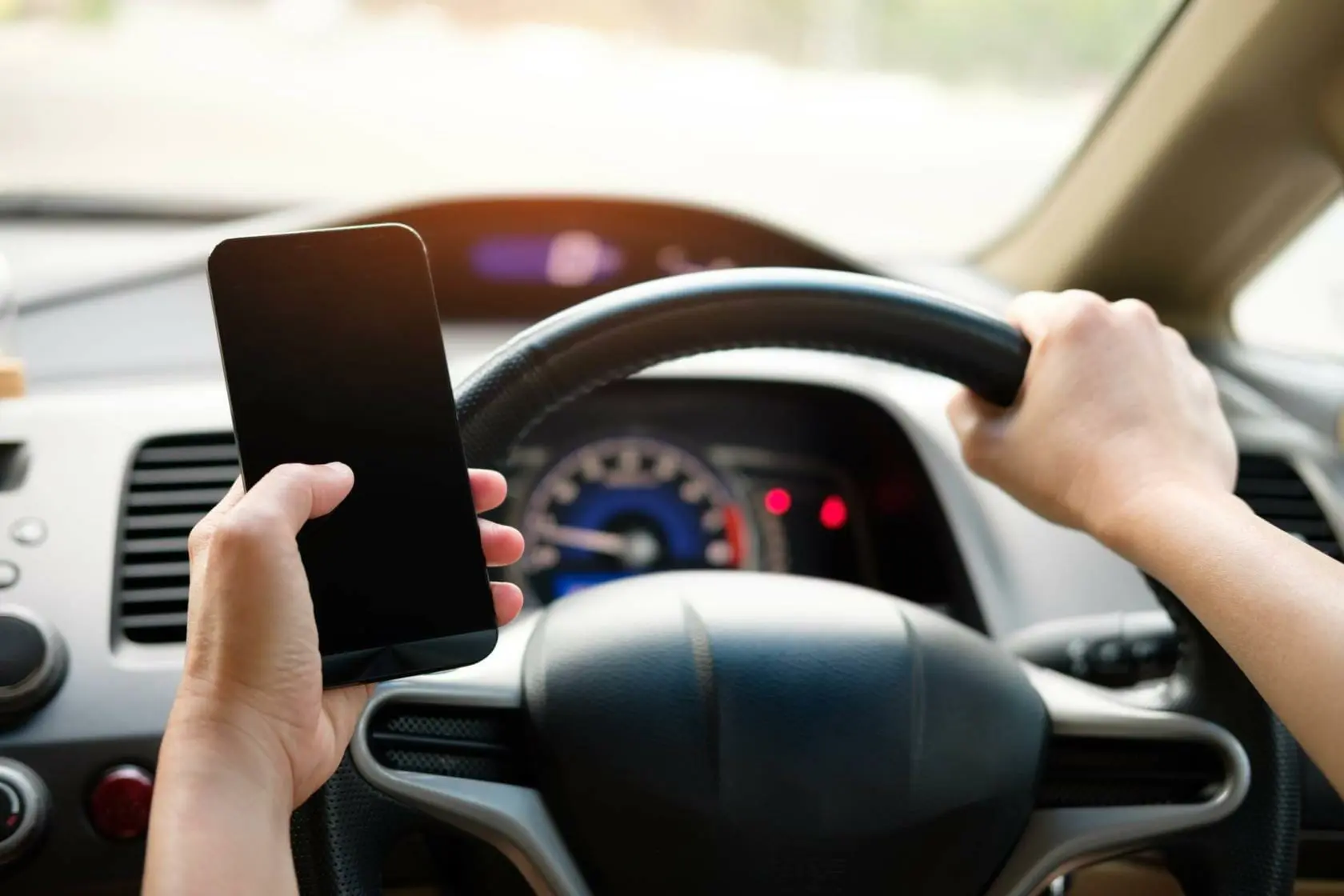 Blog 10 Driver holding cellphone while driving