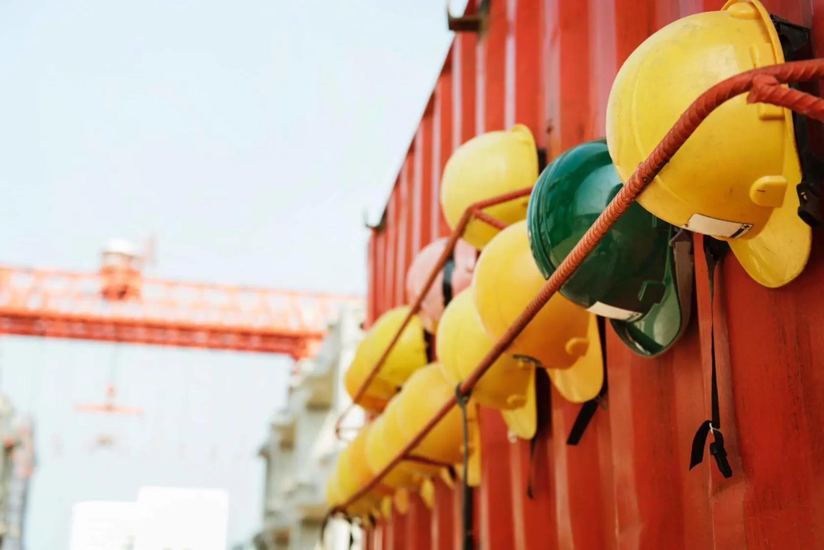 Construction safety helmets hung on side of shipping container