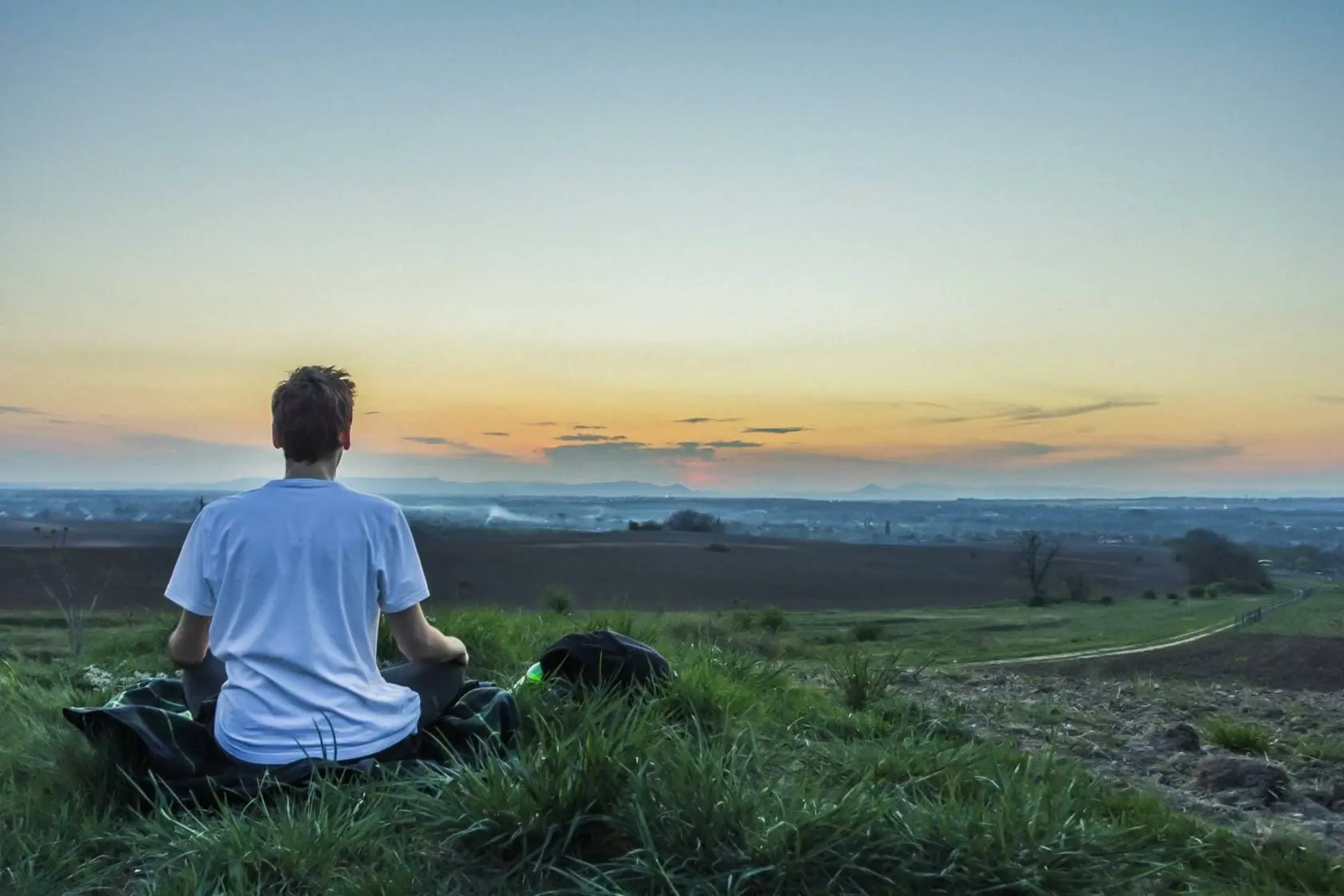 Blog 18 Man meditation on field looking at sunset