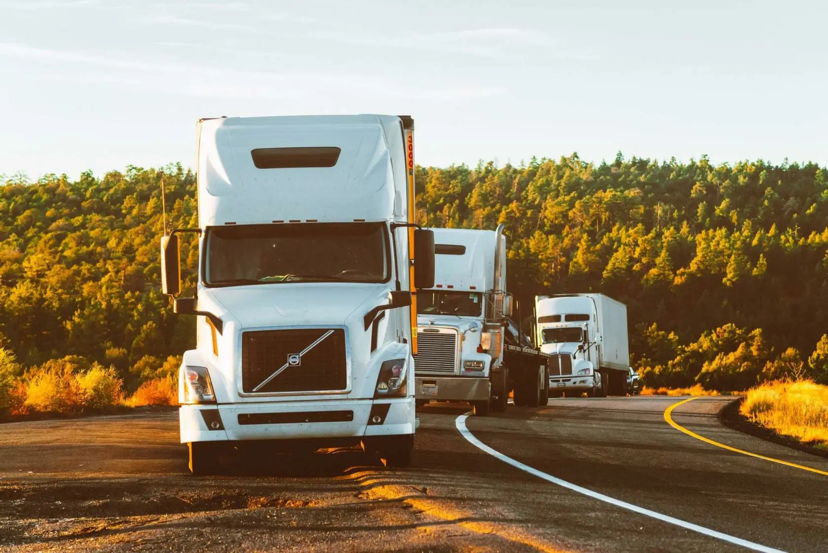 Three 18-wheeler trucks pulled over on side of road