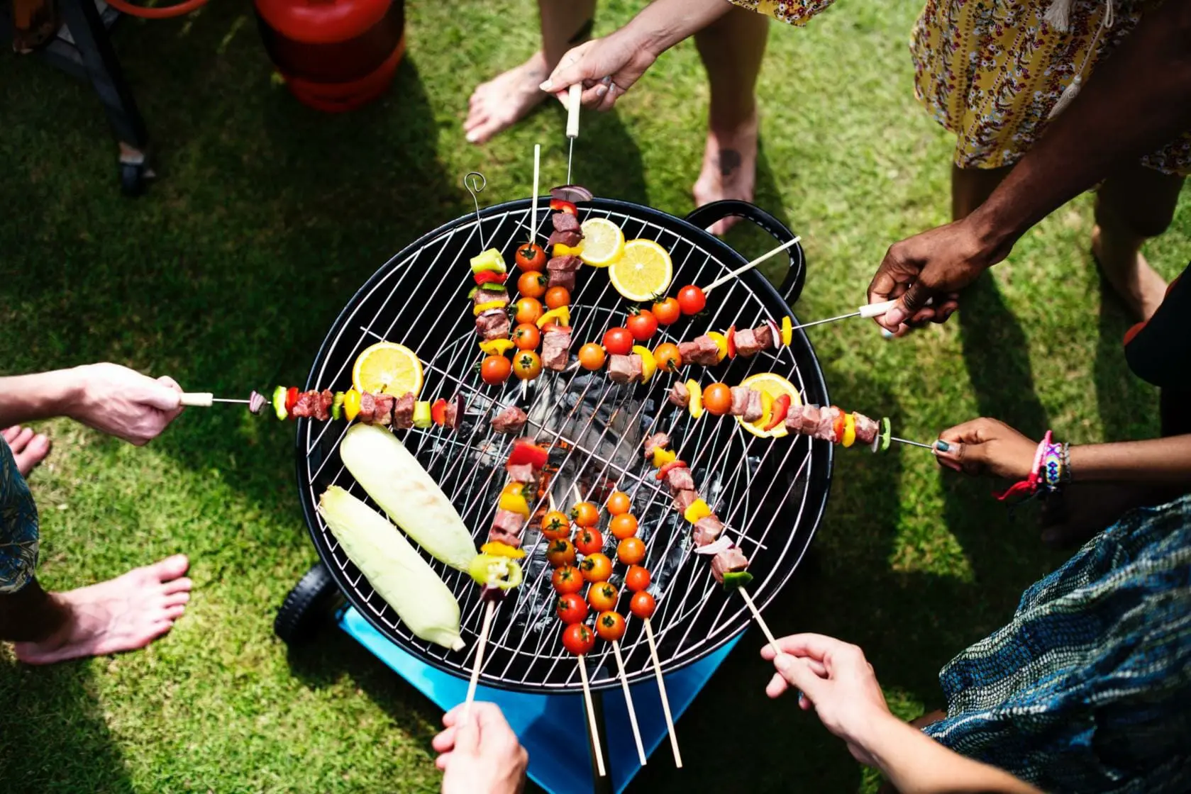 Tips for Having a Safe and Happy Labor Day During COVID-19 1 Top view of adults with kebabs over grill