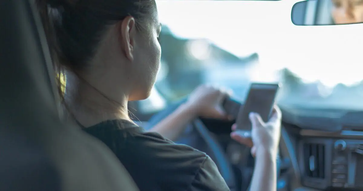 Woman using phone while driving