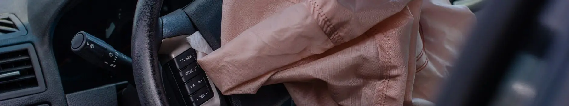 Blog 17 Close-up of steering wheel with pink airbag deployed