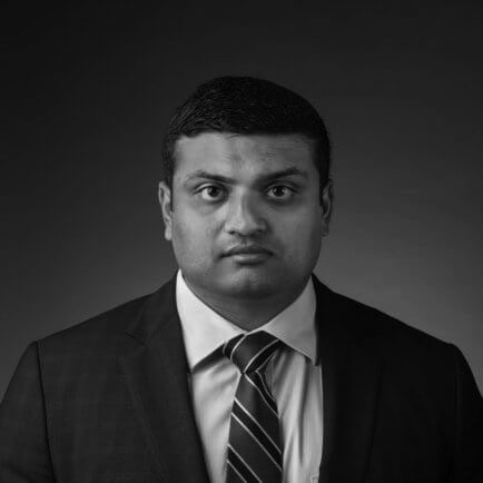 Black and white portrait photo of Thomas J. Henry Attorney Chirag N. Desai
