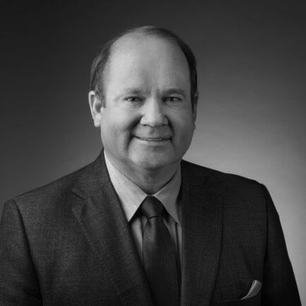 Black and white portrait photo of Thomas J. Henry Attorney Roger L. Turk