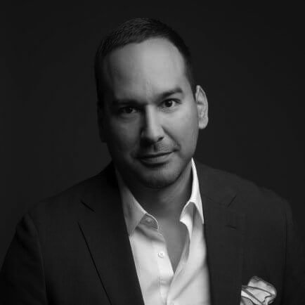 Black and white portrait photo of Thomas J. Henry Attorney Ruben G. Herrera