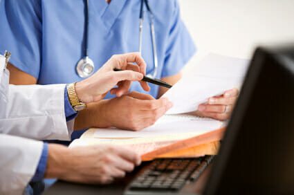 Doctor and nurse reviewing paperwork