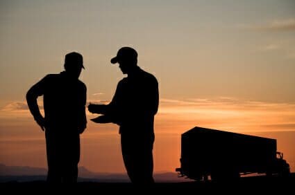 1 Killed, 2 Injured in Dump Truck Crash 1 Silhouette of two men signing a document in front of a truck