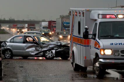 Damaged car from an accident with responding ambulance