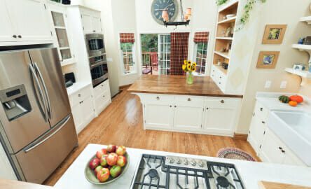 High angle of a contemporary classic design showcase kitchen interior with view to outdoor patio deck.