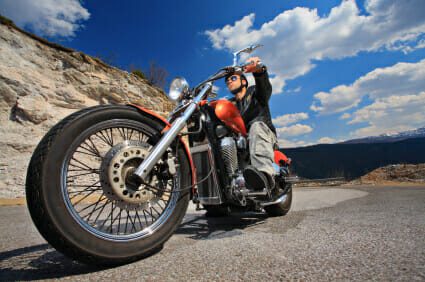 Man on orange motorcycle