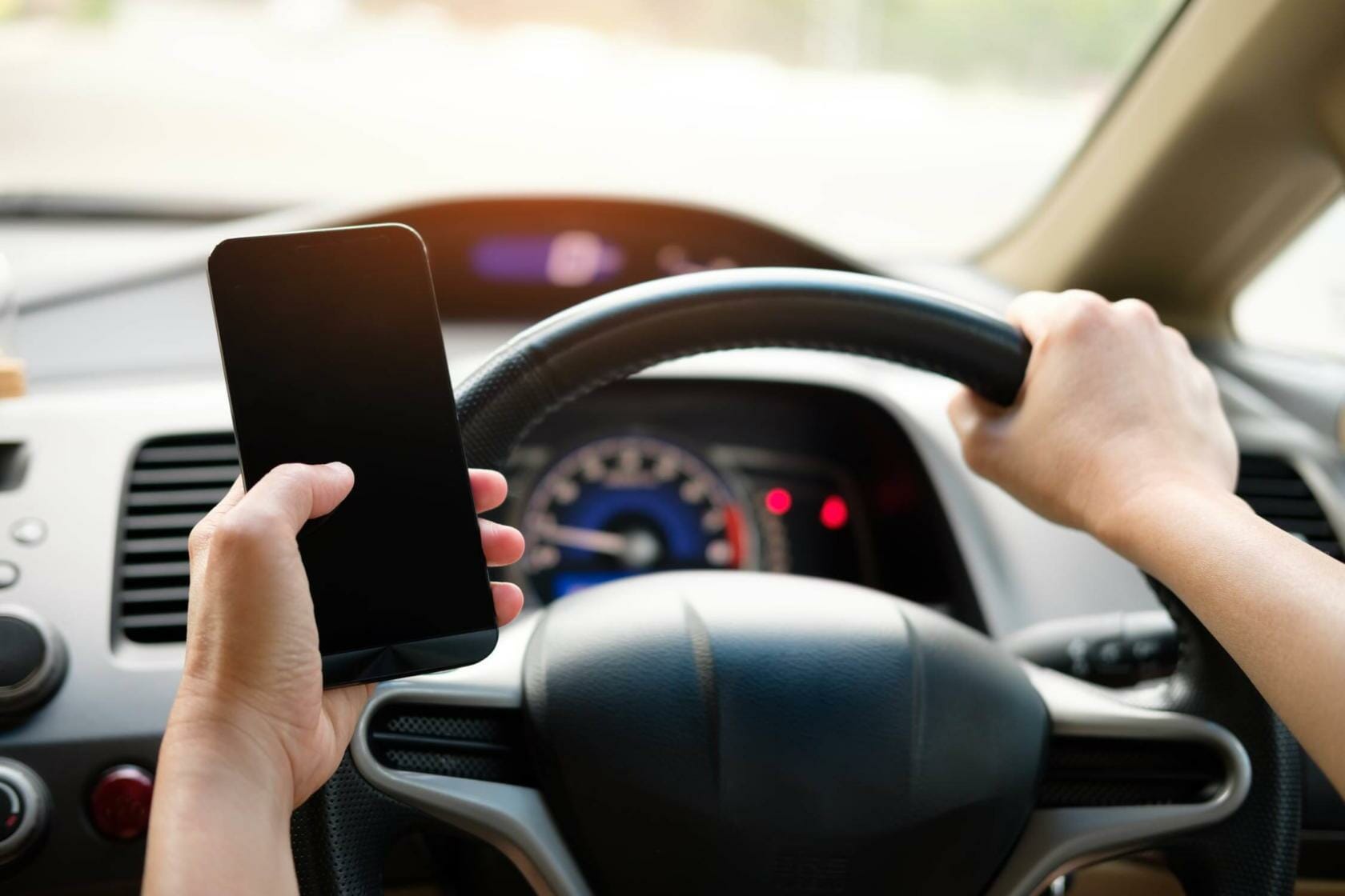 Driver holding cellphone while driving