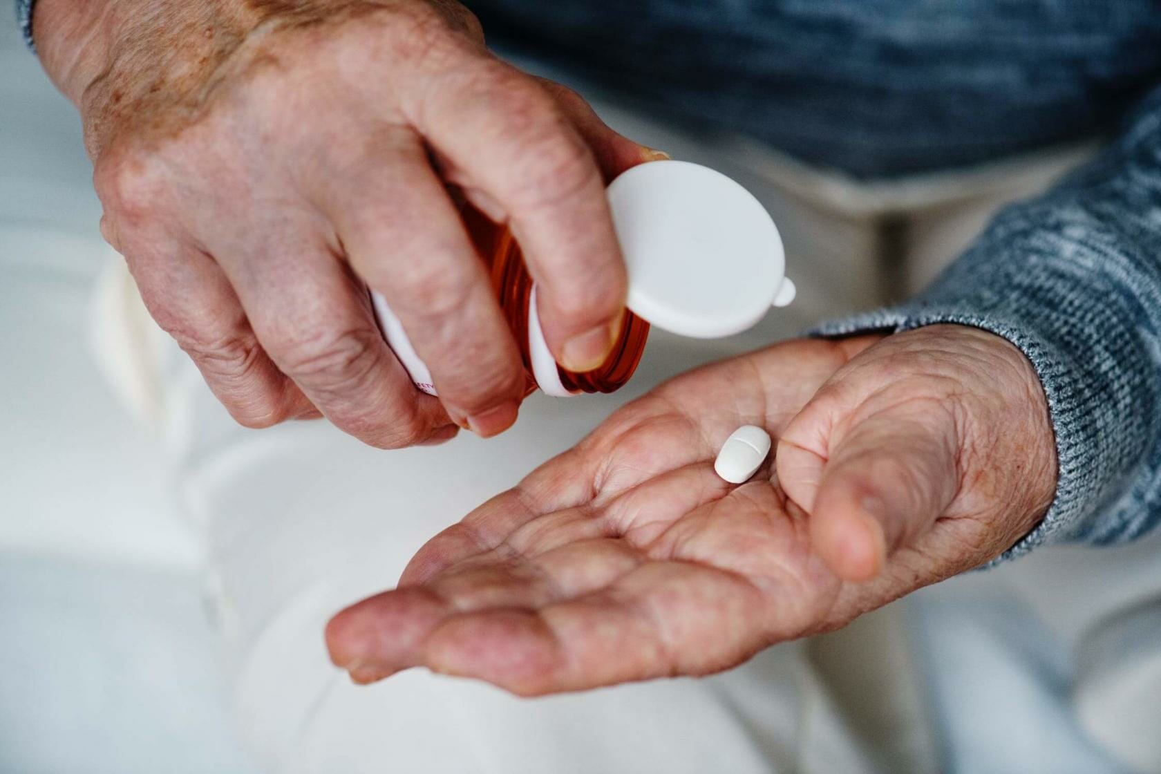 Elderly man taking medication