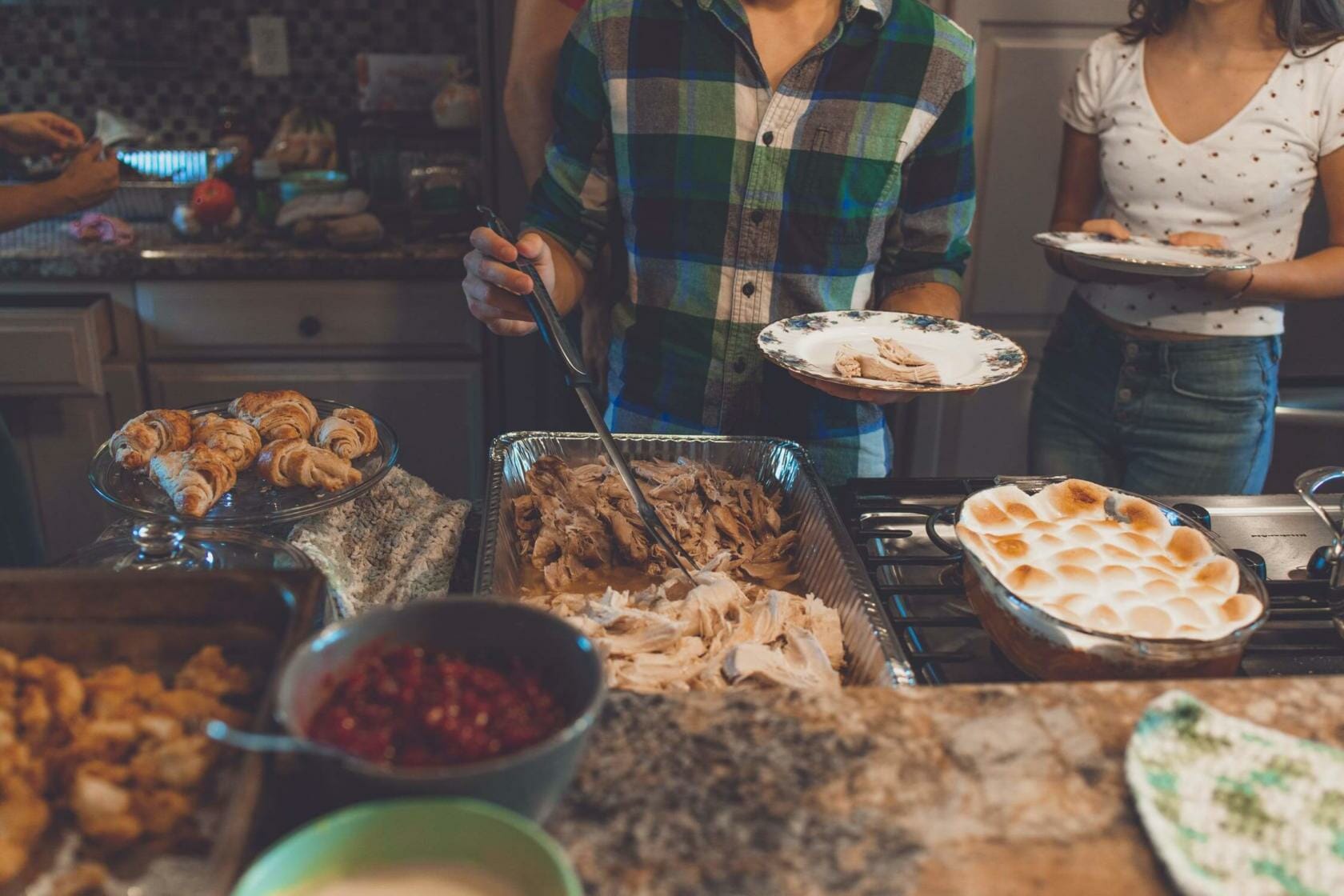 Family serving Thanksgiving dinner