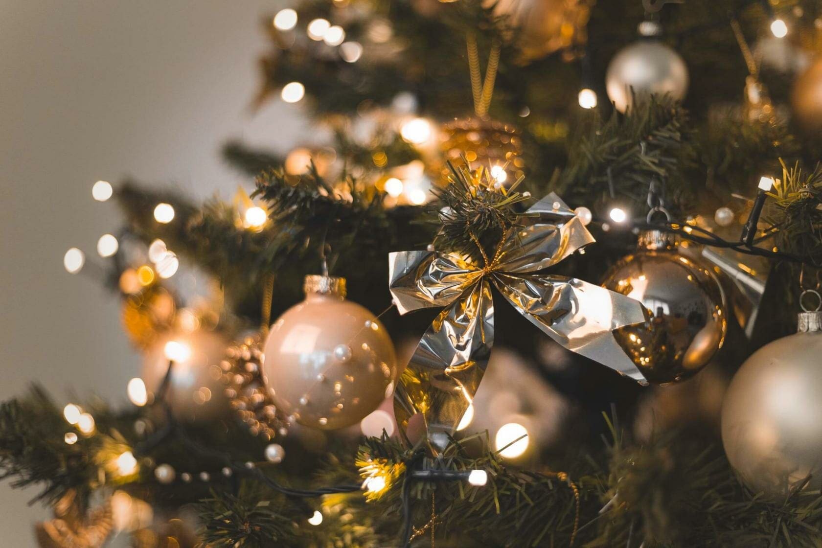 Christmas tree with gold ornament and a ribbon