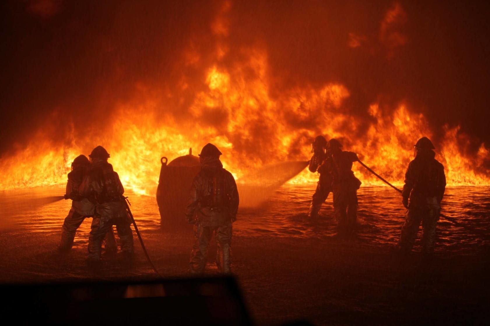 Firefighters putting out industrial fire