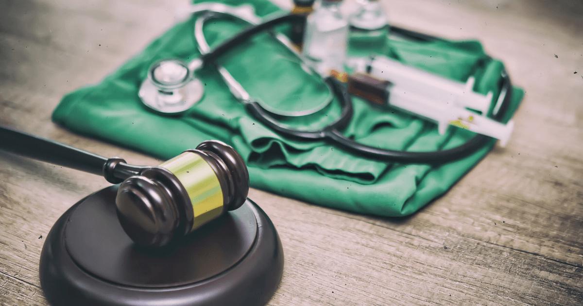 Gavel, stethoscope, and medical instruments