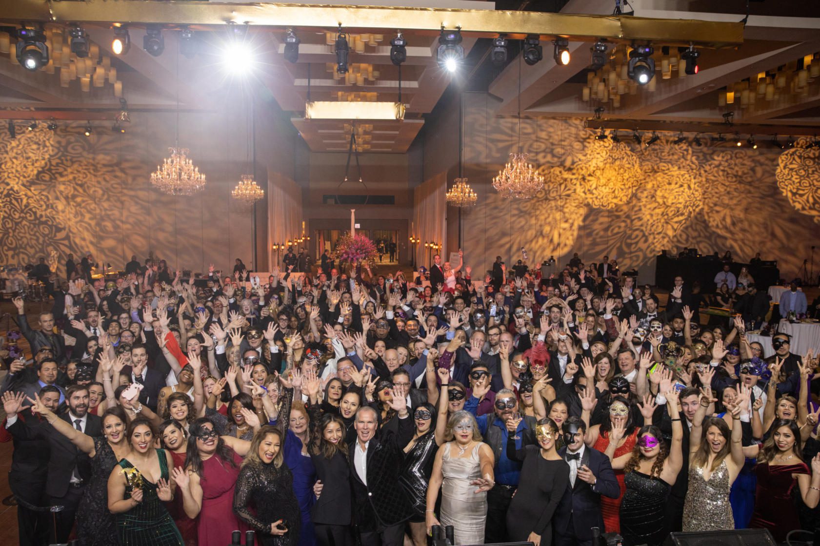 Thomas J. Henry with friends and staff posing during the 2019 Christmas Party